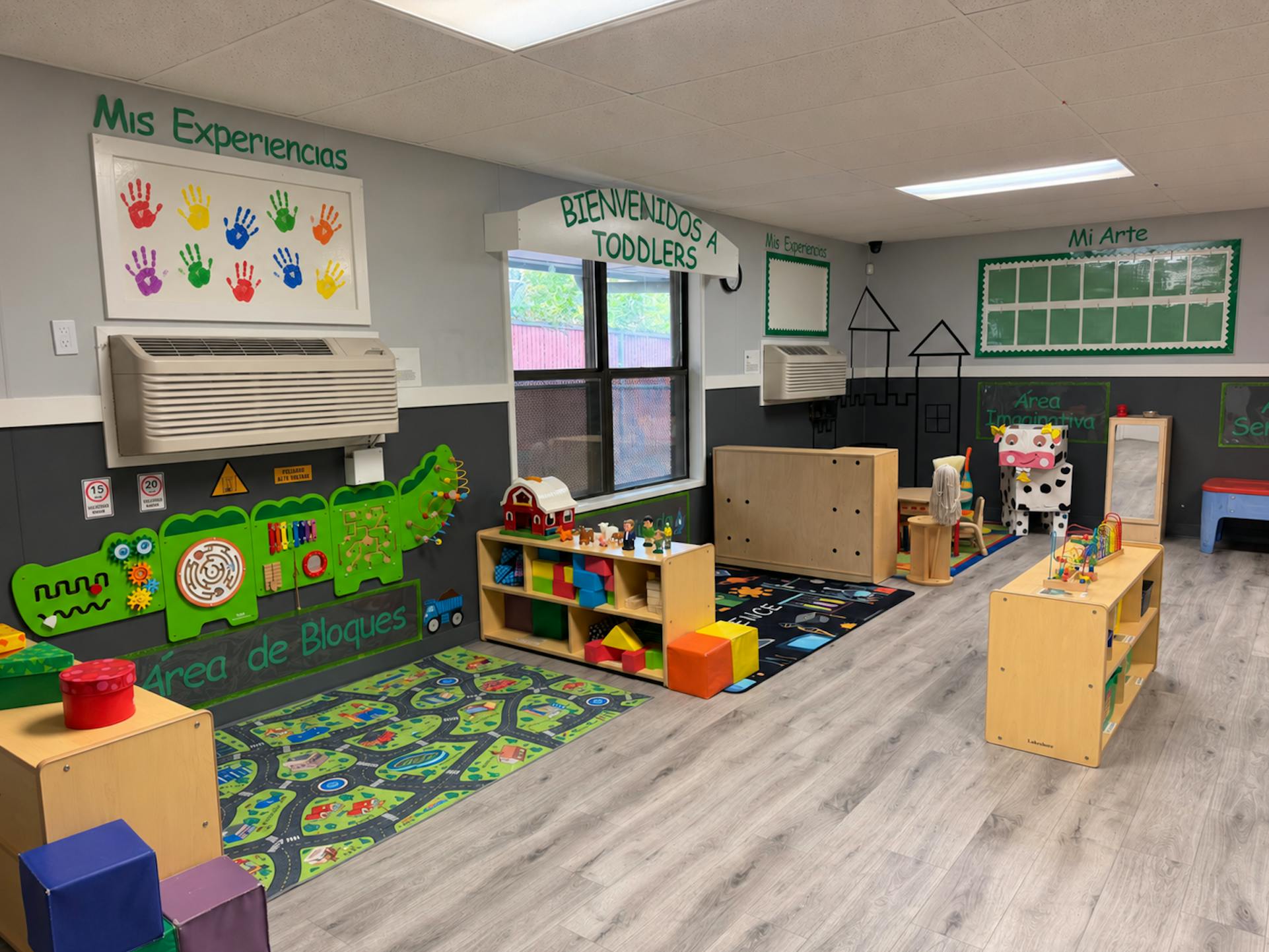 Colorful early childhood classroom with activity stations and toys