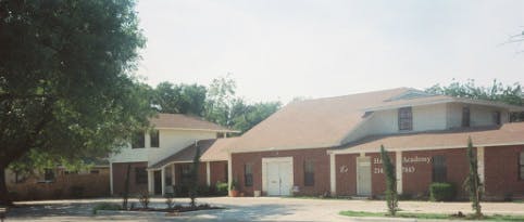 Building with brick facade and light-colored roof