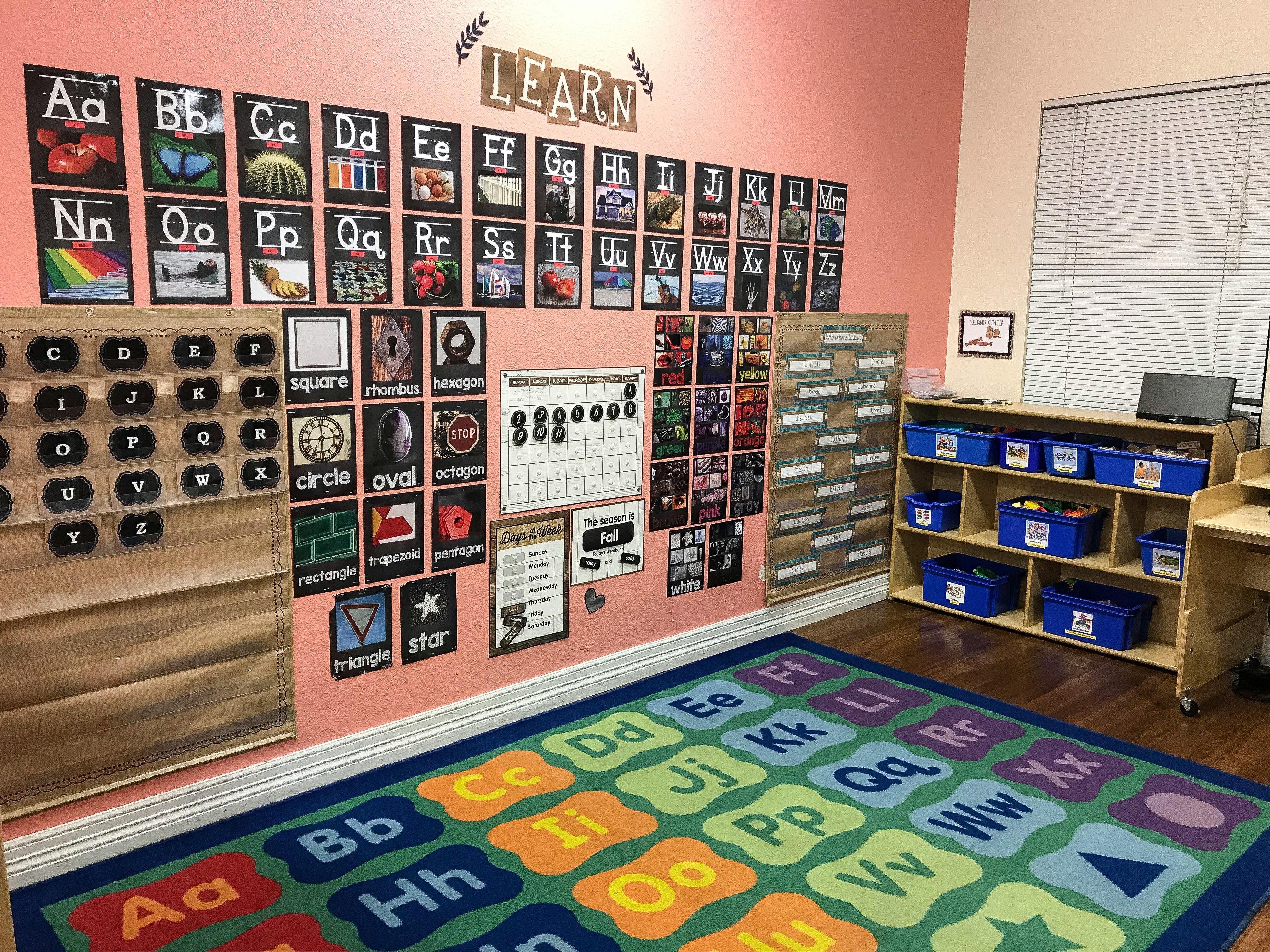 Classroom with alphabet posters, calendar, and alphabet rug