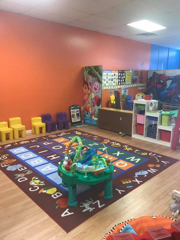 Playroom with alphabet rug and children's toys