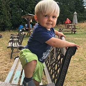 Child standing on a bench