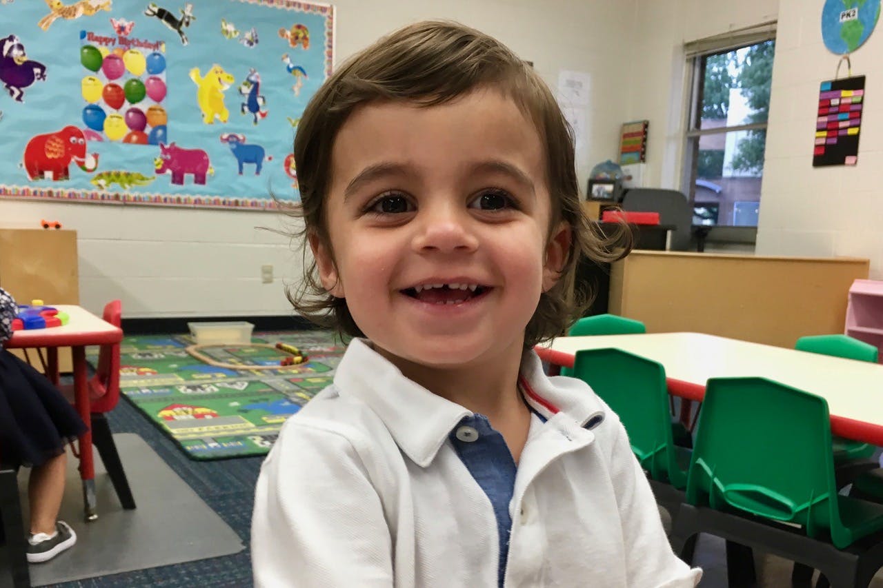 Child smiling in a classroom