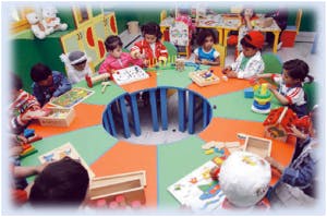 Children playing with toys around a table
