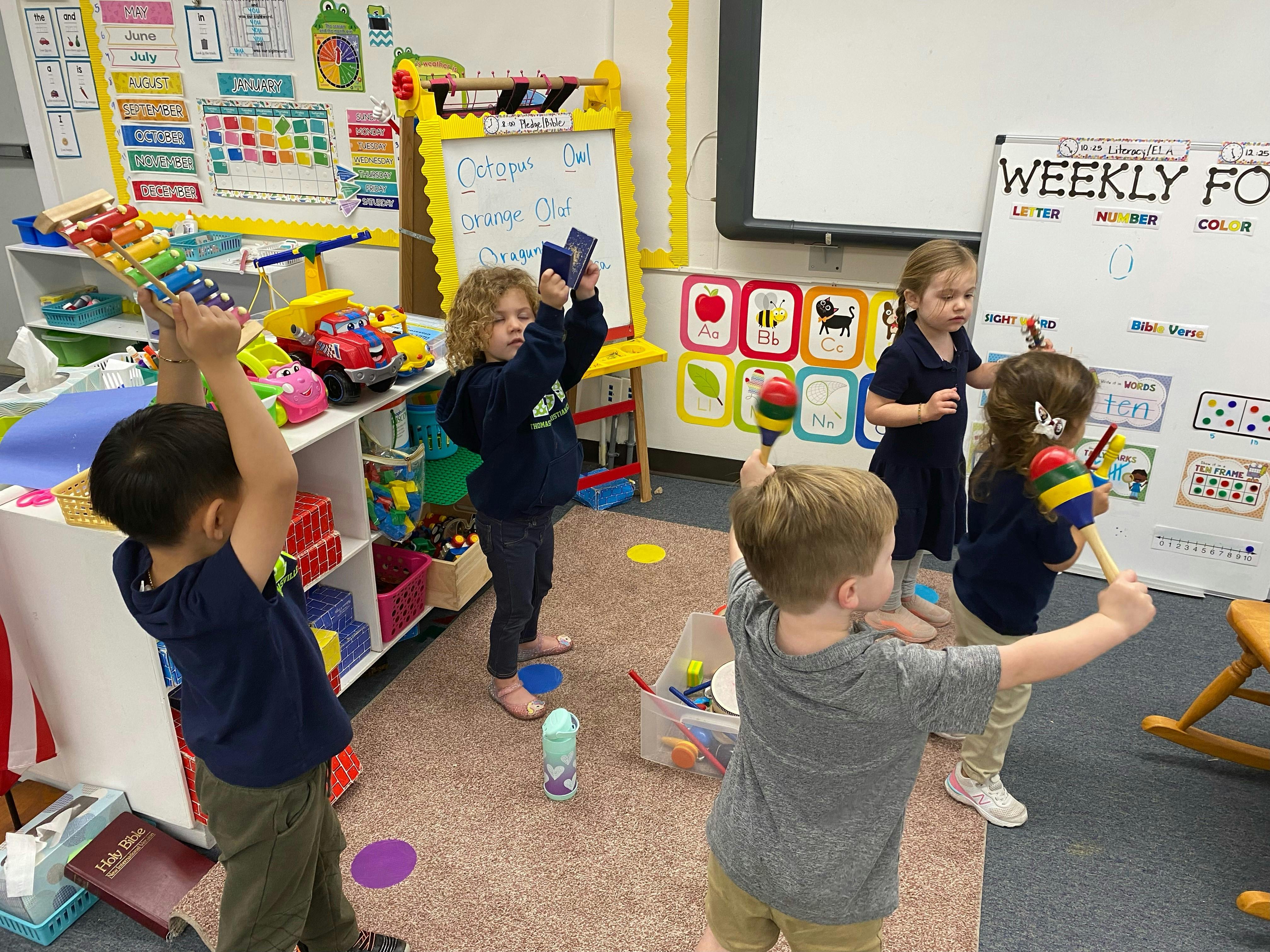 Children playing with musical instruments in a classroom