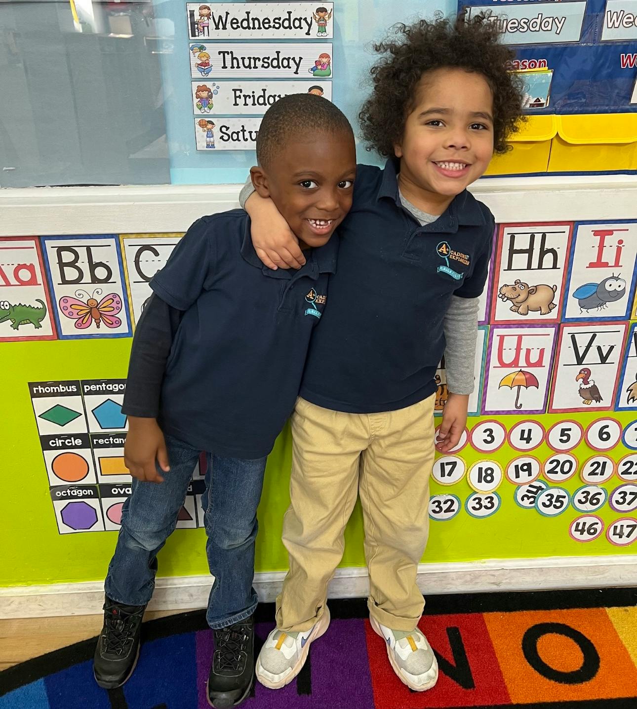 Two children standing with arms around each other