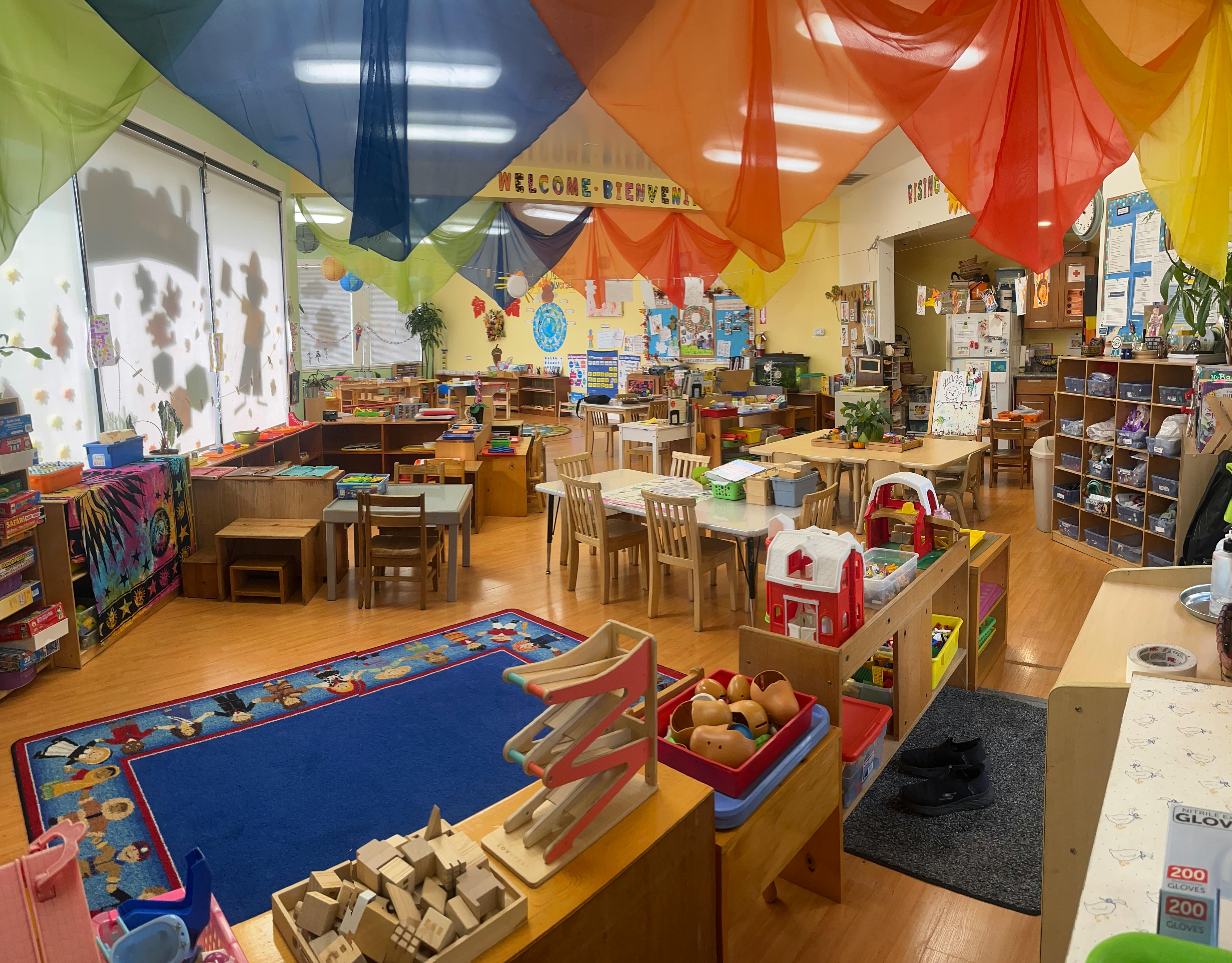 Preschool classroom with colorful fabric draped from the ceiling