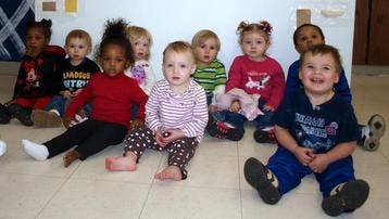 Group of young children sitting on the floor