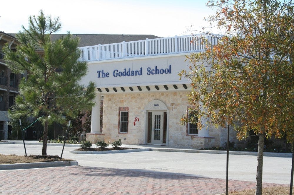 The Goddard School building exterior with trees