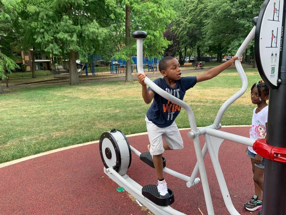 Child on an outdoor elliptical machine