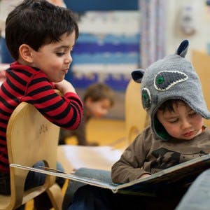 Two children looking at a book