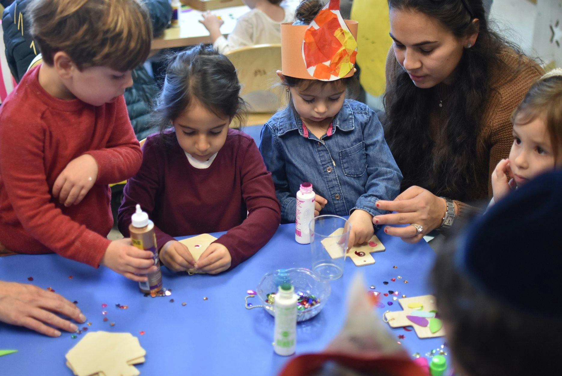 Adult and children crafting at a table