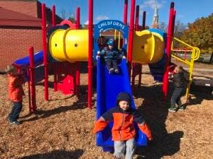 Children playing on a playground slide