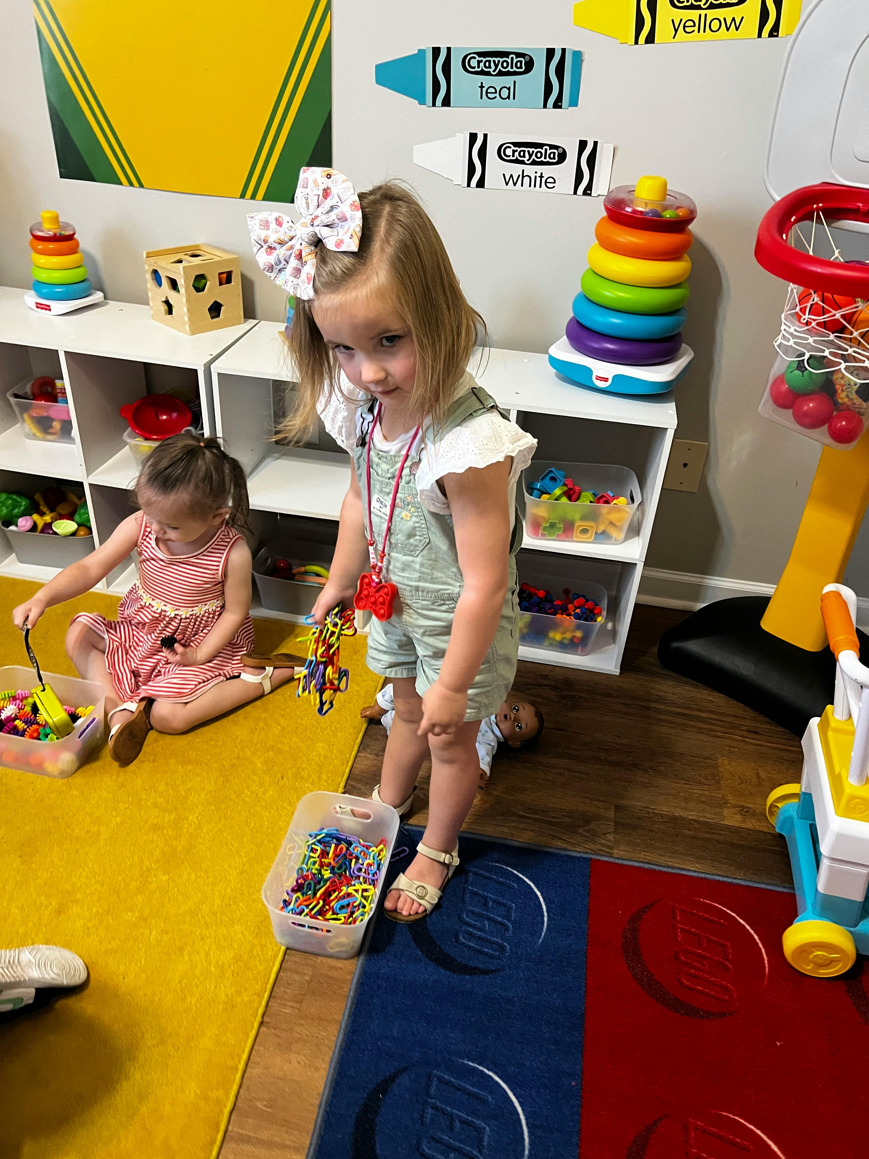 Two children playing with toys on the floor