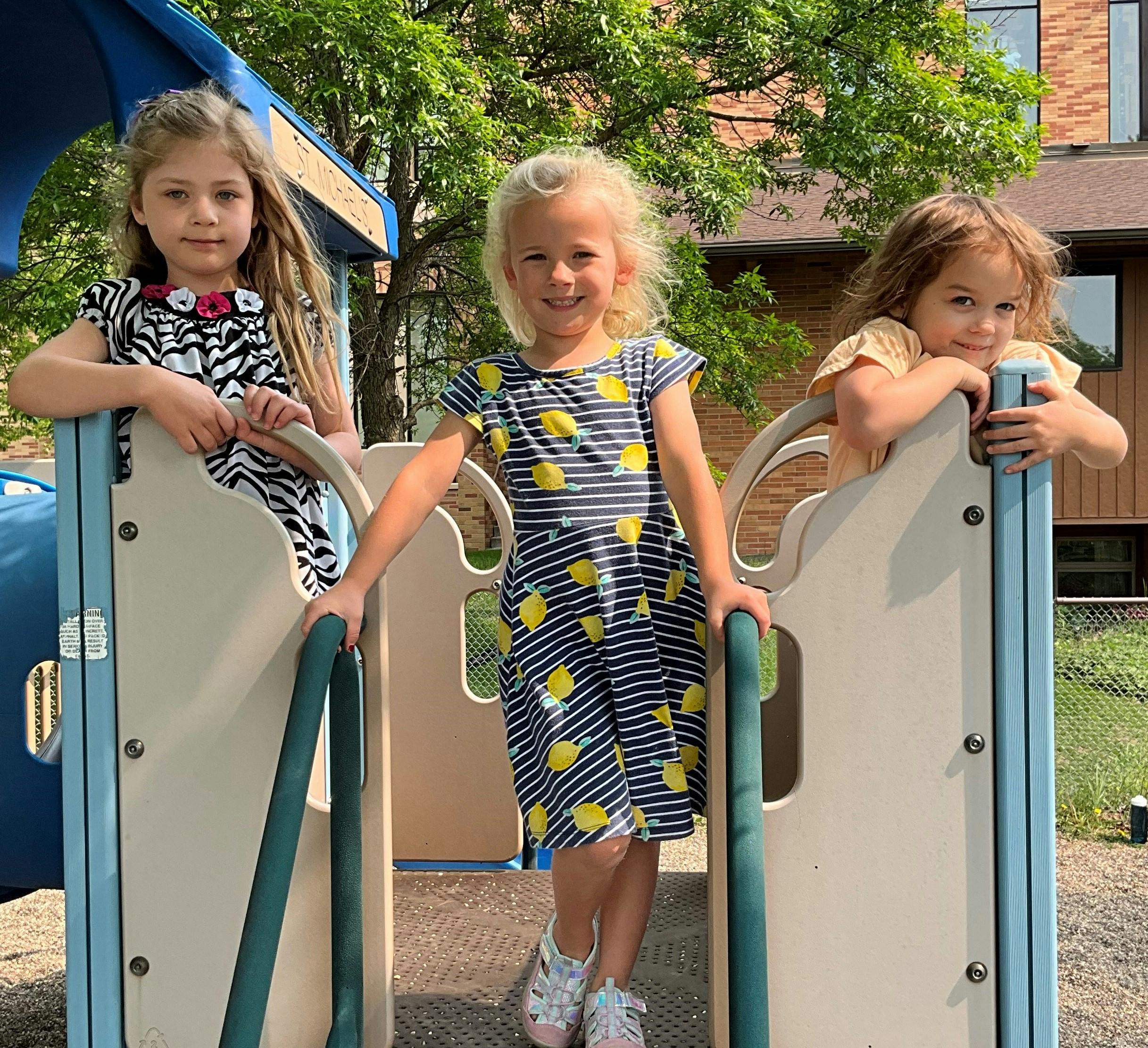 Three children on a playground structure