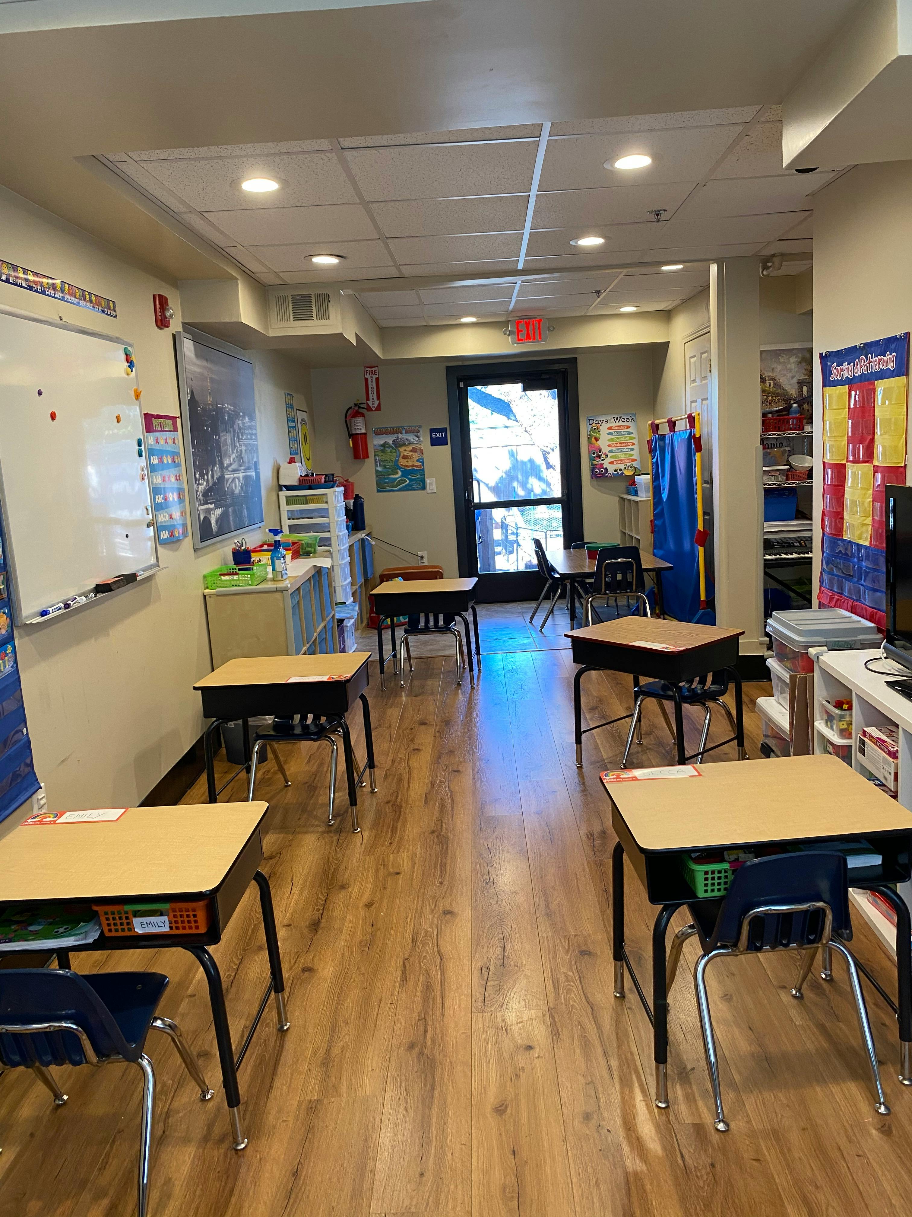 Classroom with rows of empty student desks and chairs