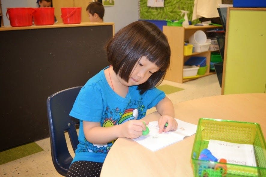 Child drawing at a table