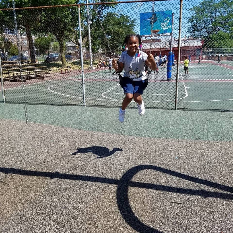 Child on a swing set in mid-air