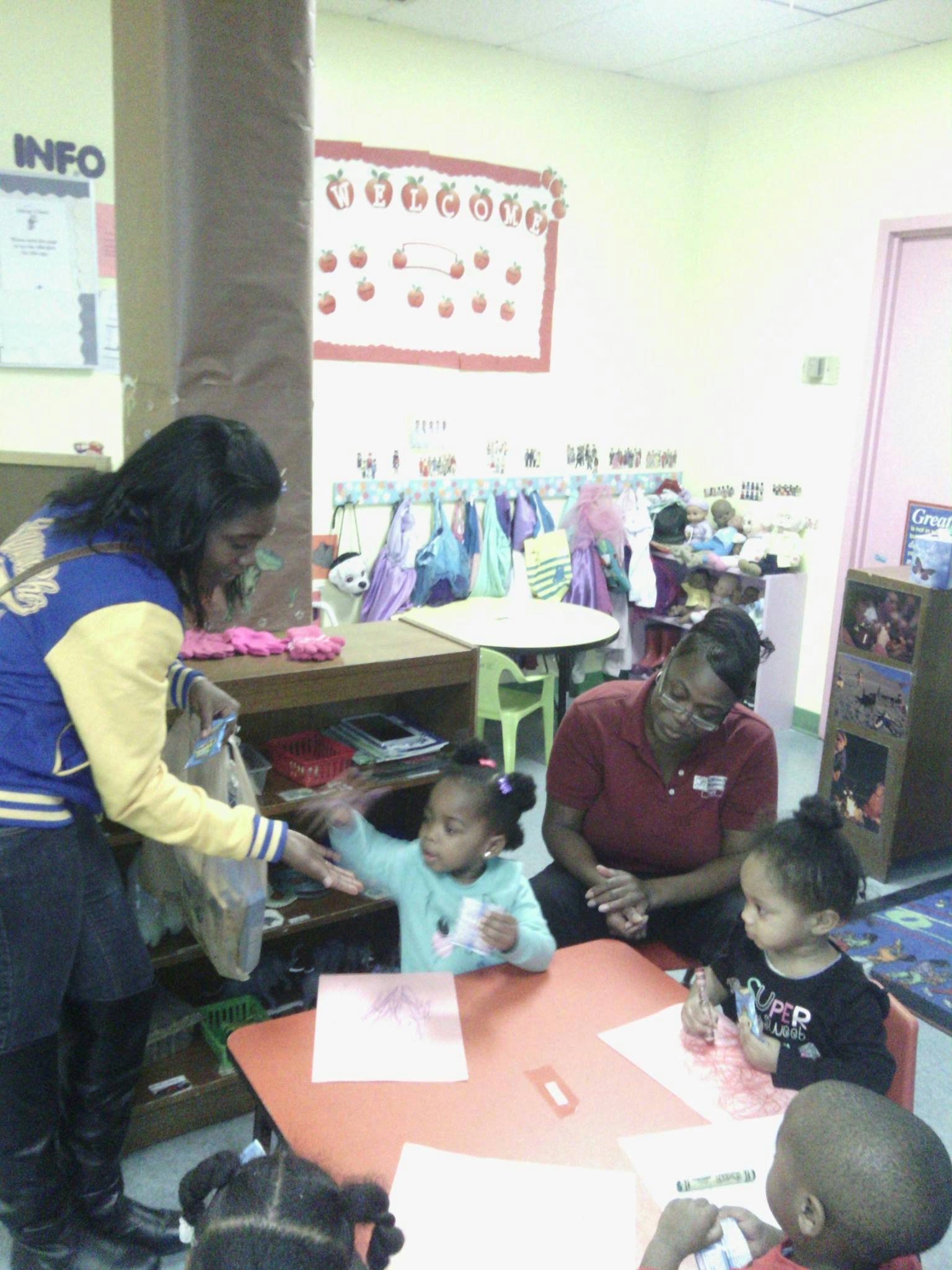 Adults and children interacting in a classroom