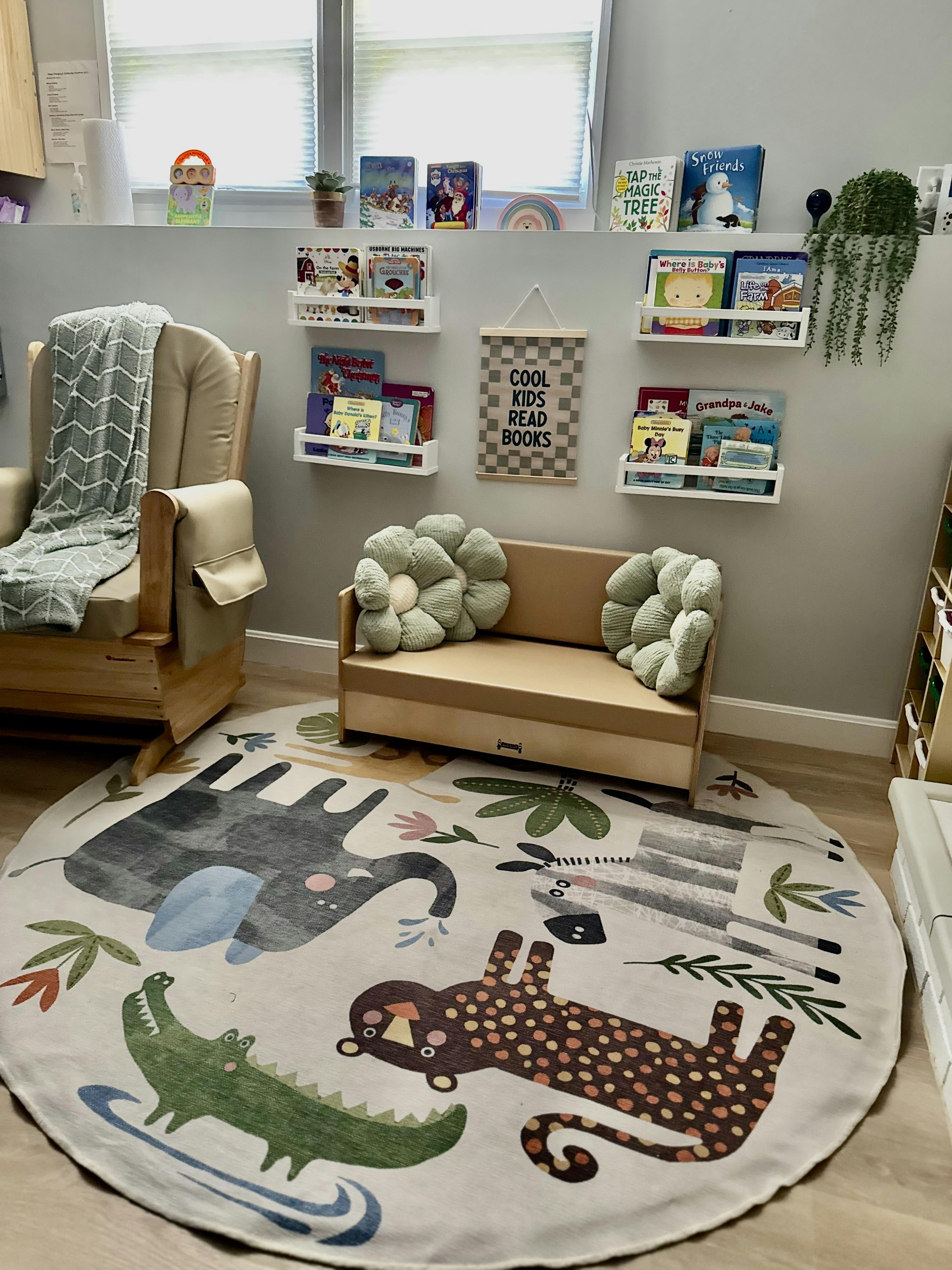 Children reading corner with animal rug, small bench, and wall-mounted bookshelves