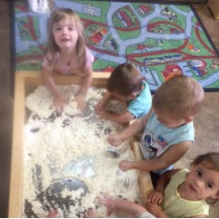 Children playing in a sand table