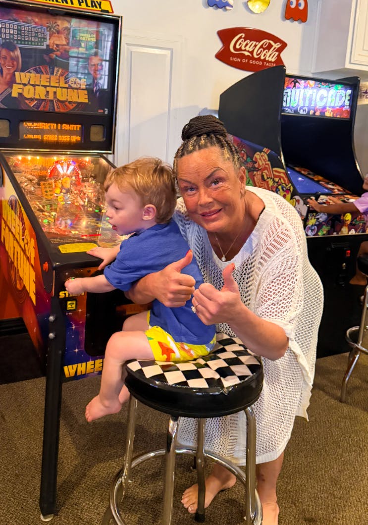 Person and child playing pinball