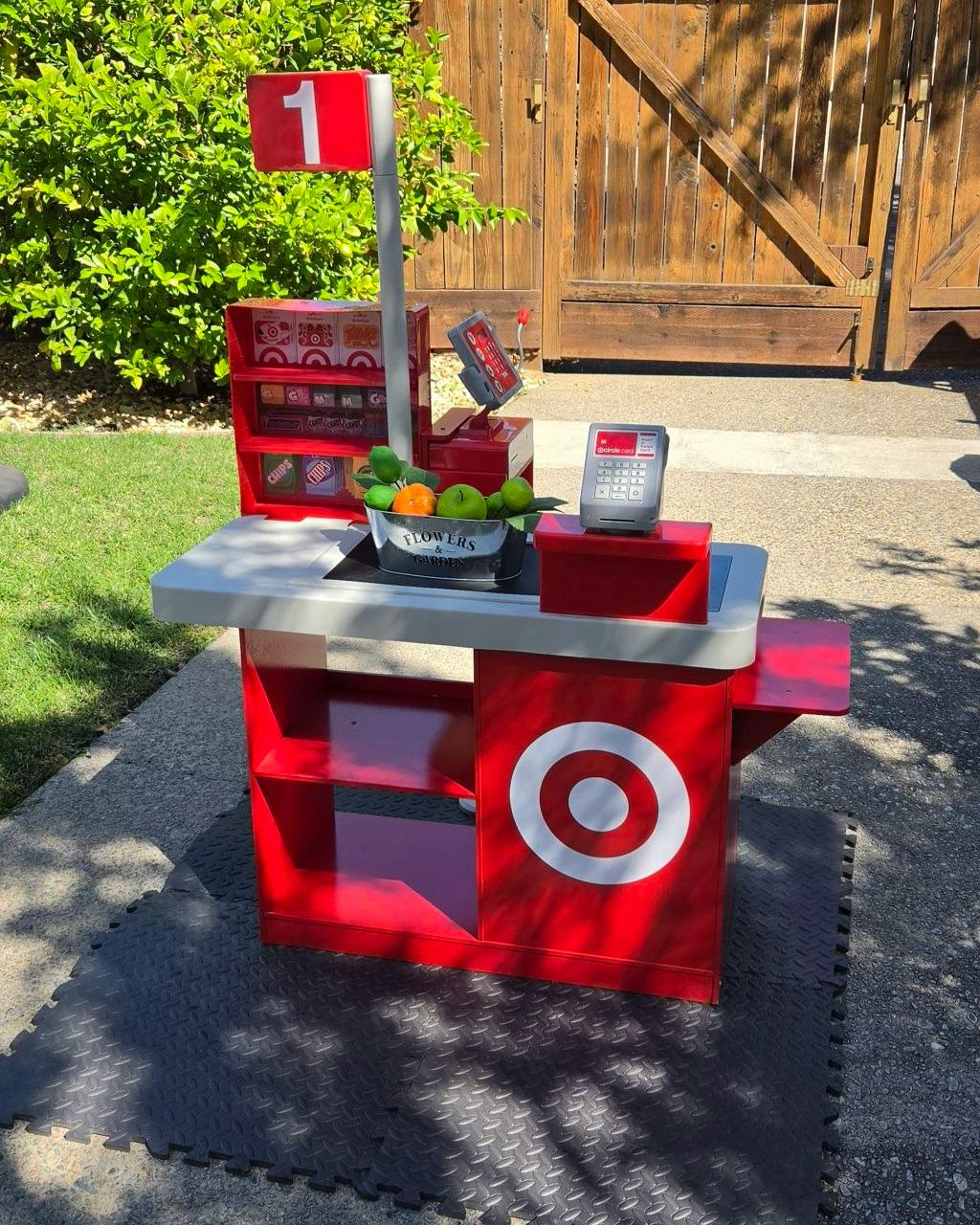 Toy store checkout stand with fruit and a red Target bullseye logo