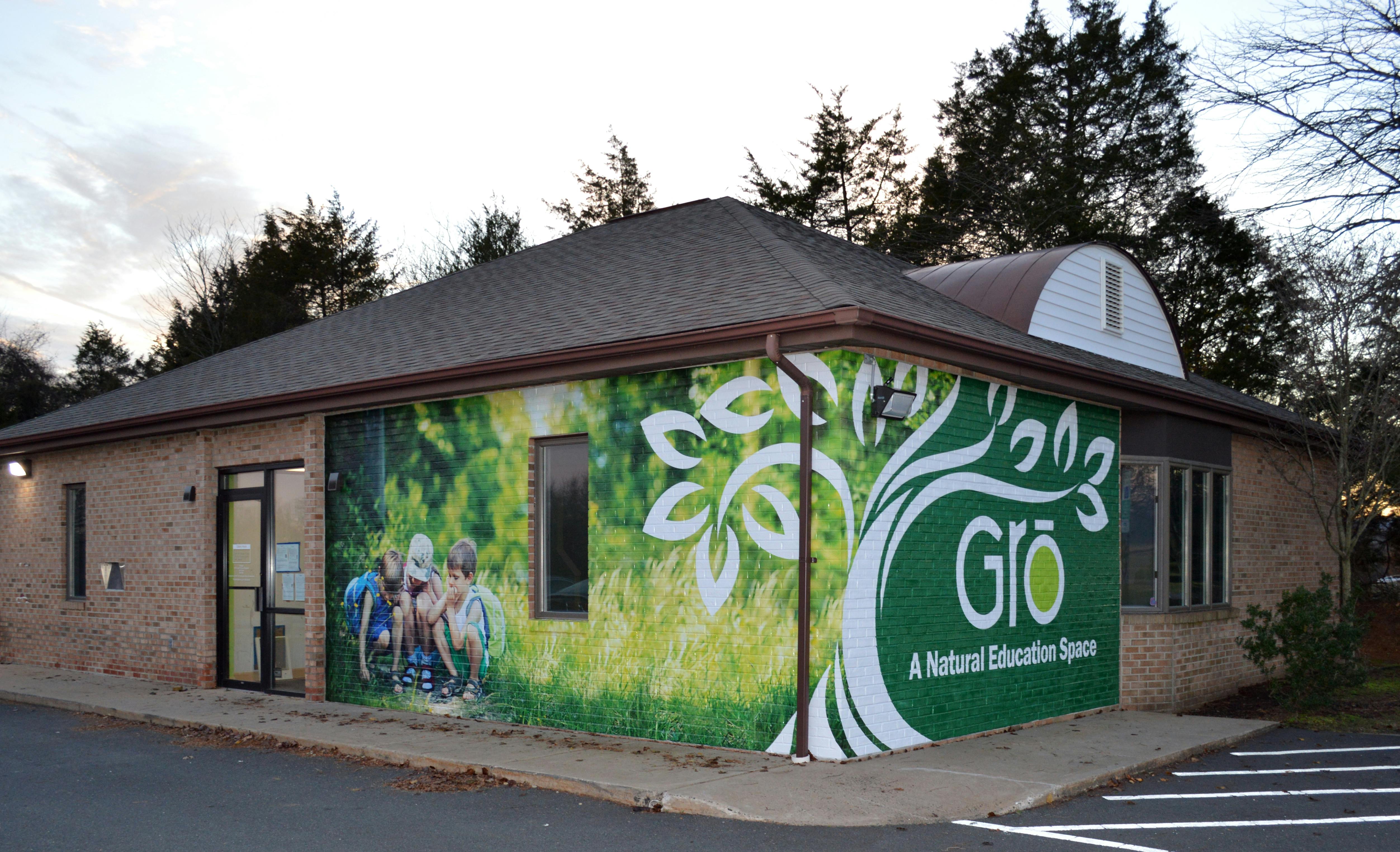 Building with a mural of a tree and the text "GRO A Natural Education Space"