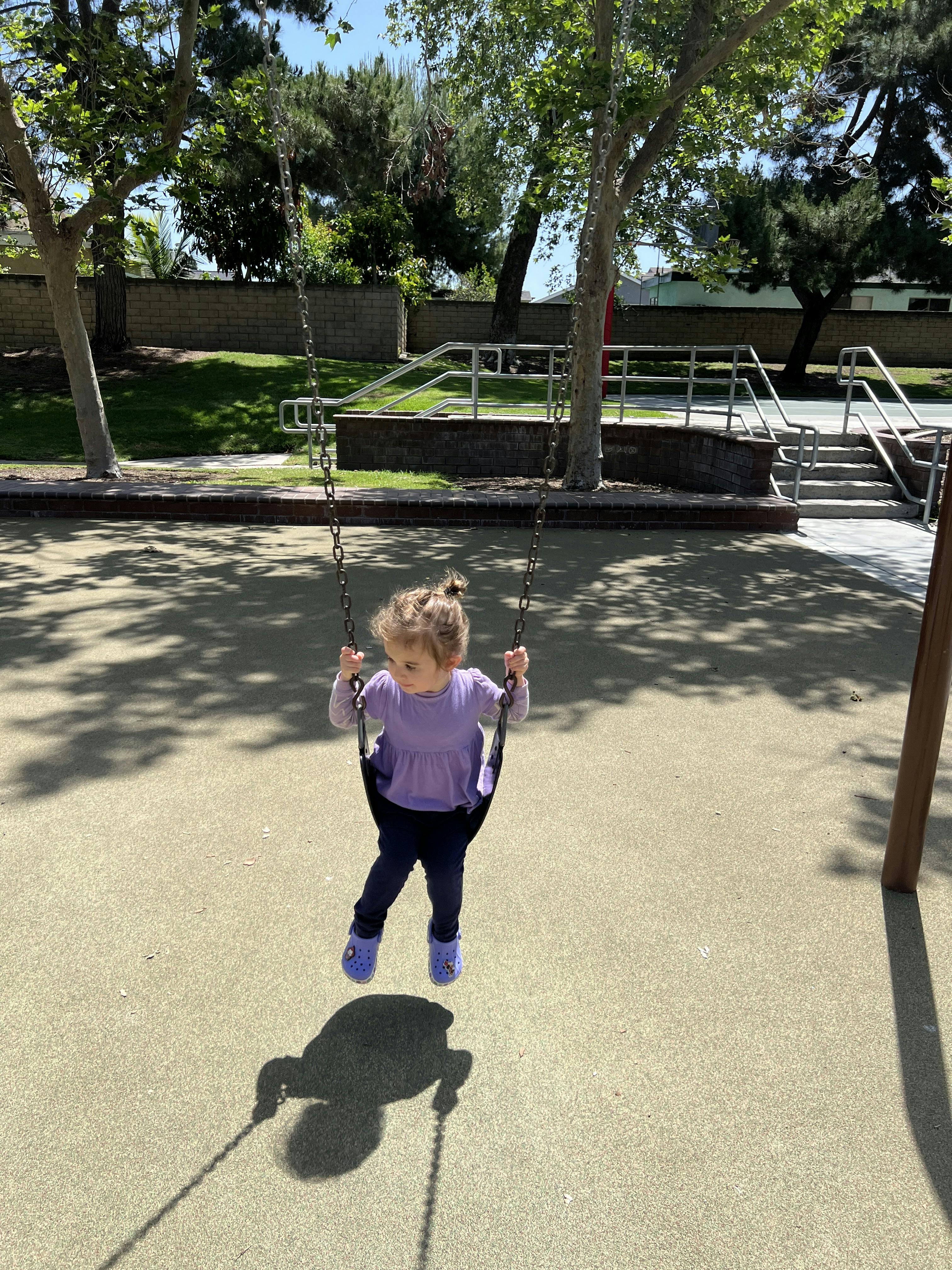 Child swinging on a playground swing