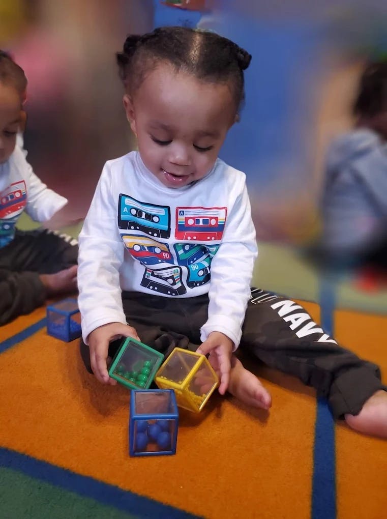Child playing with colorful blocks on the floor