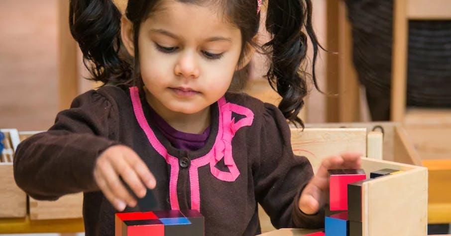 Child playing with colorful blocks