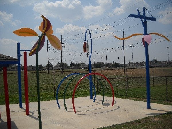 Water play area with colorful arches and a large pinwheel