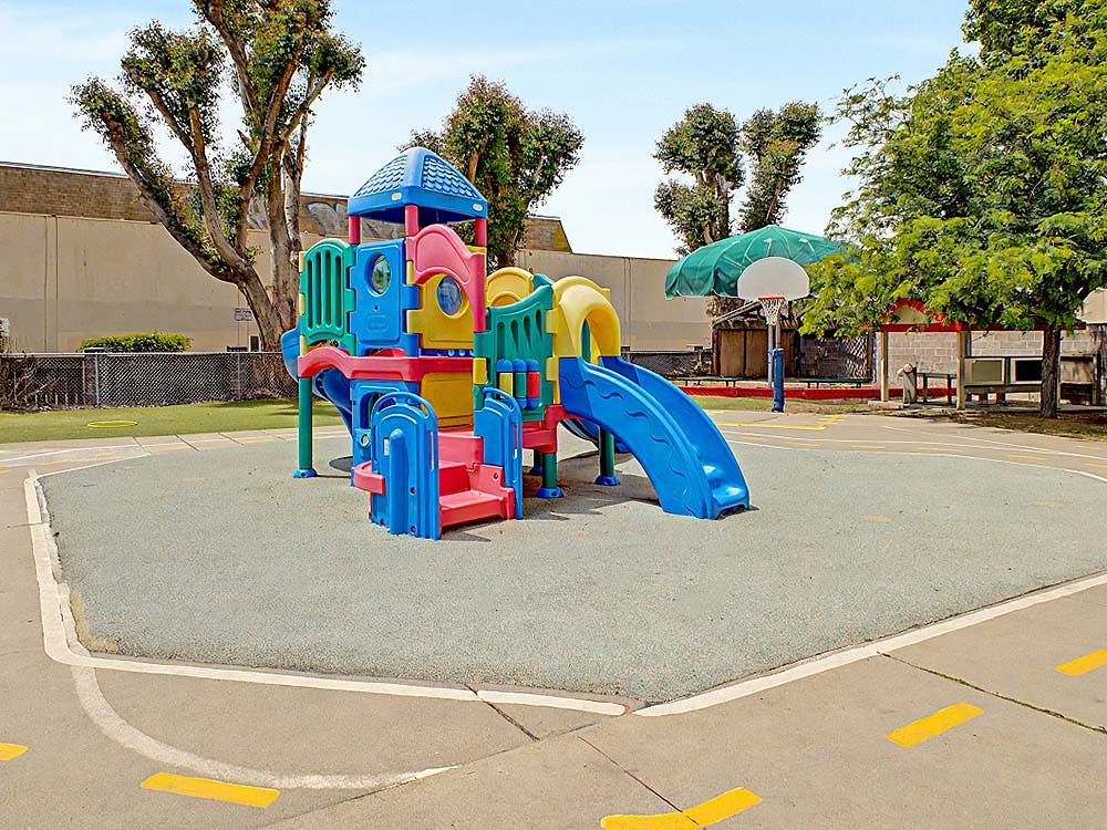 Colorful playground structure with slides on a soft surface