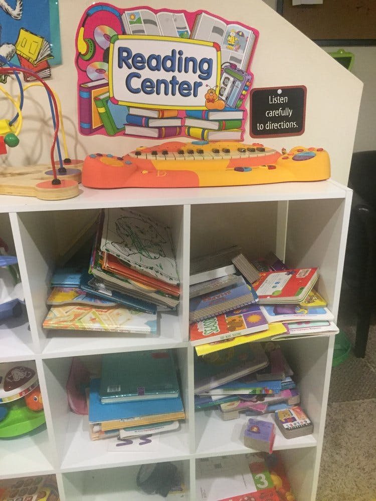 Reading Center sign above shelves of books and toys