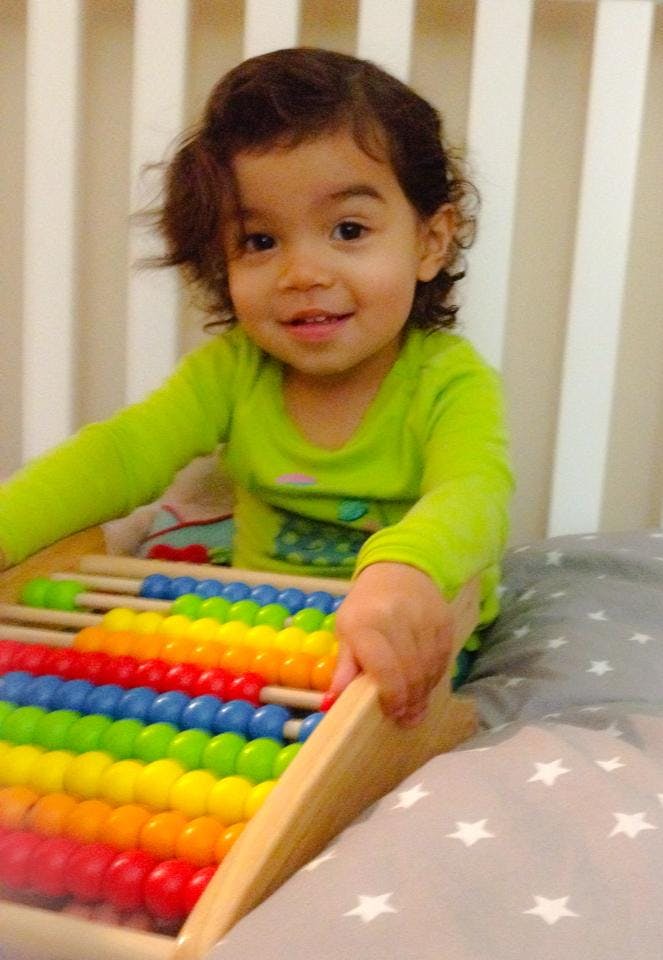 Child playing with a colorful abacus