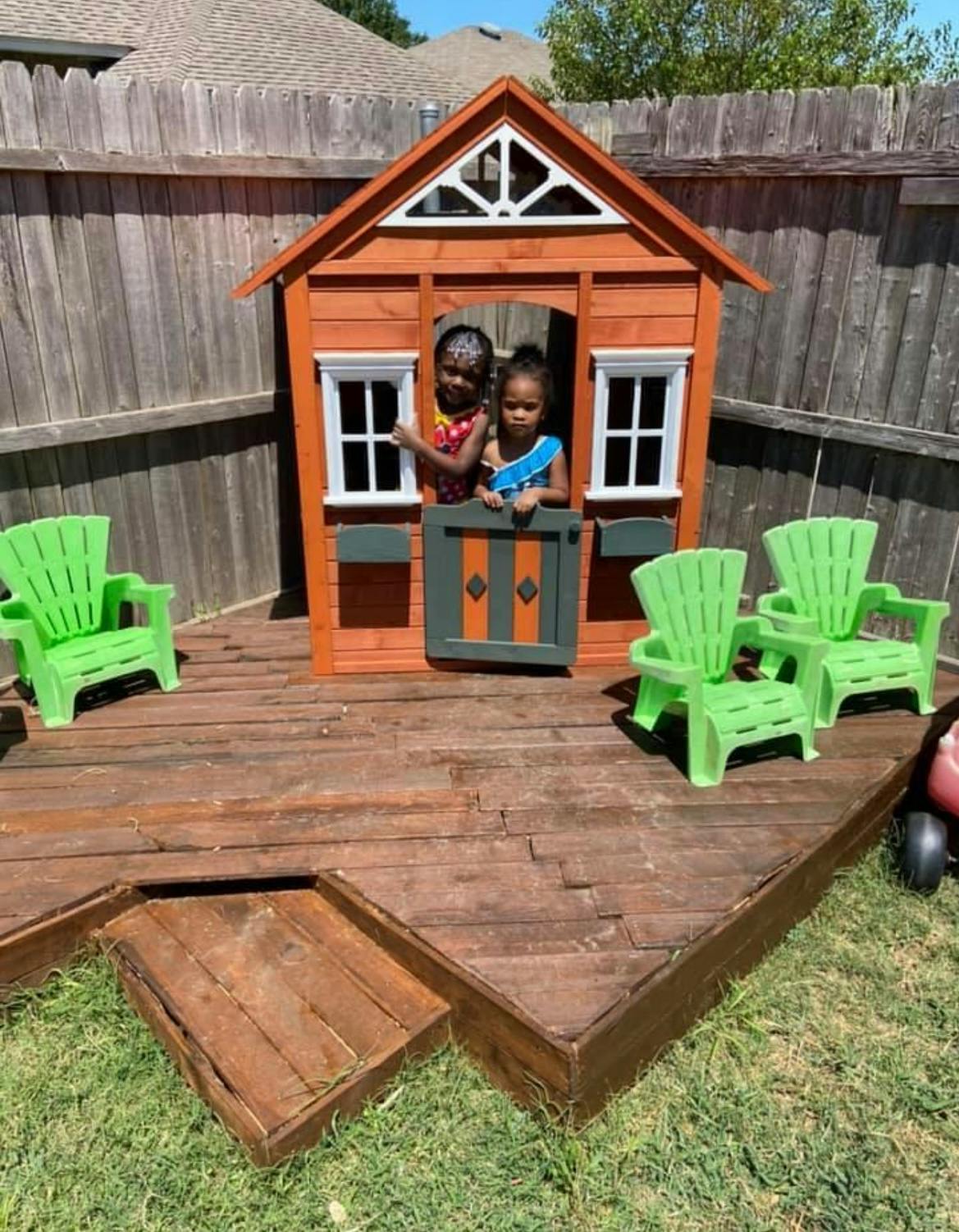 Two children looking out from a playhouse window