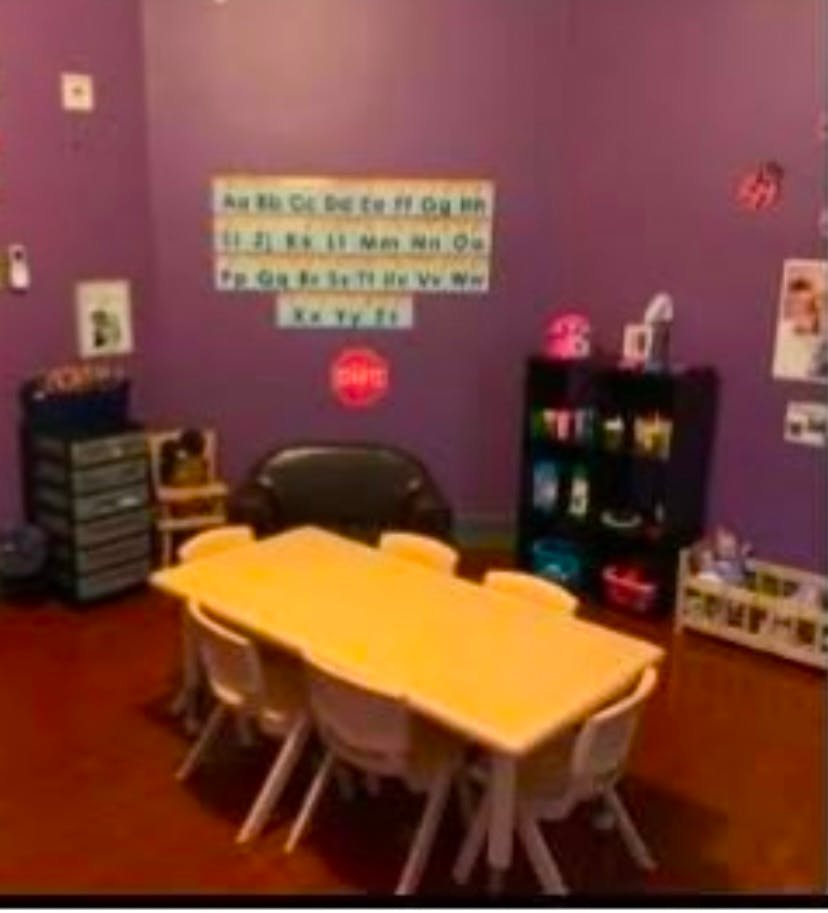 Classroom with small table and chairs, alphabet chart on wall