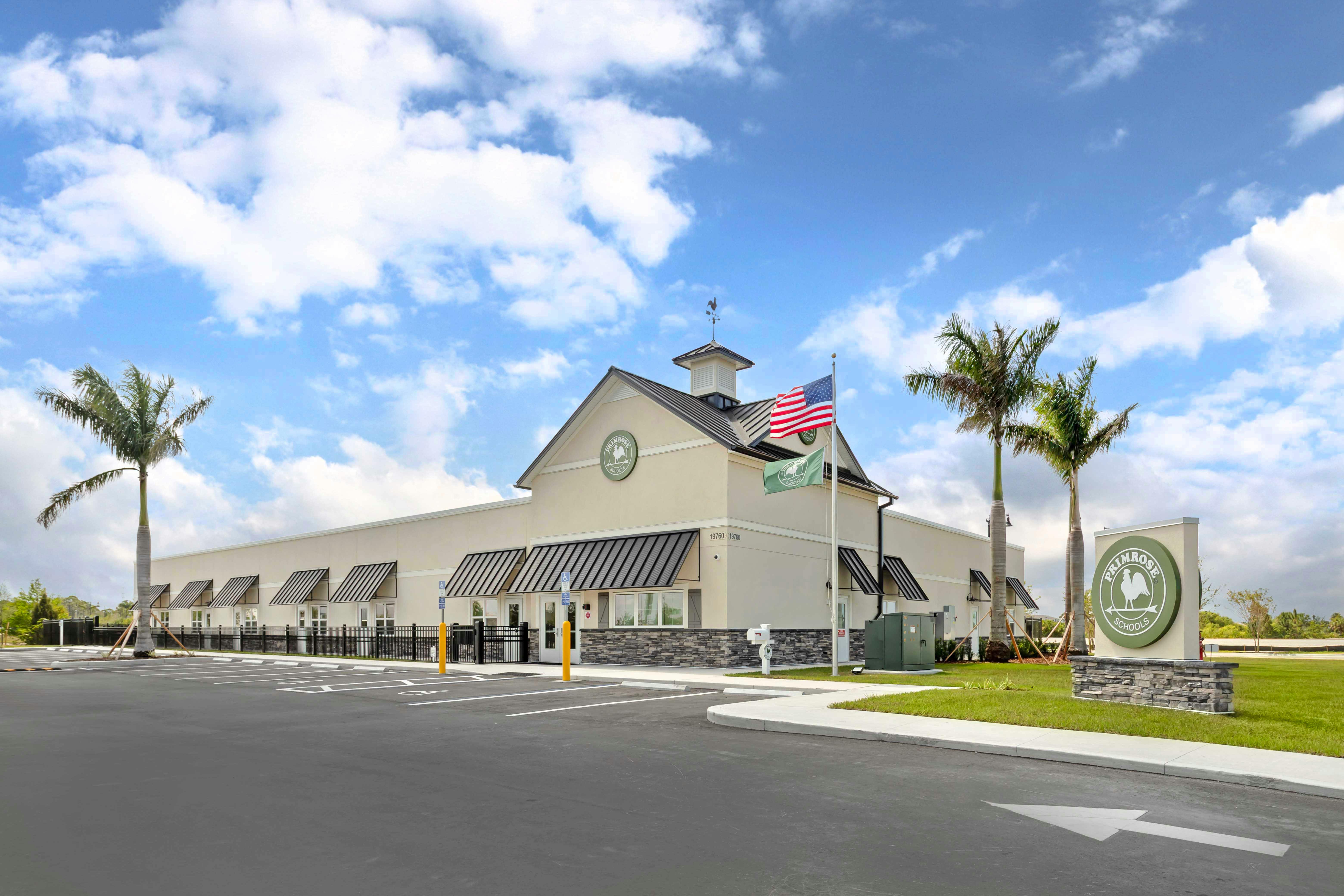 Exterior view of a Primrose Schools building with a parking lot in front