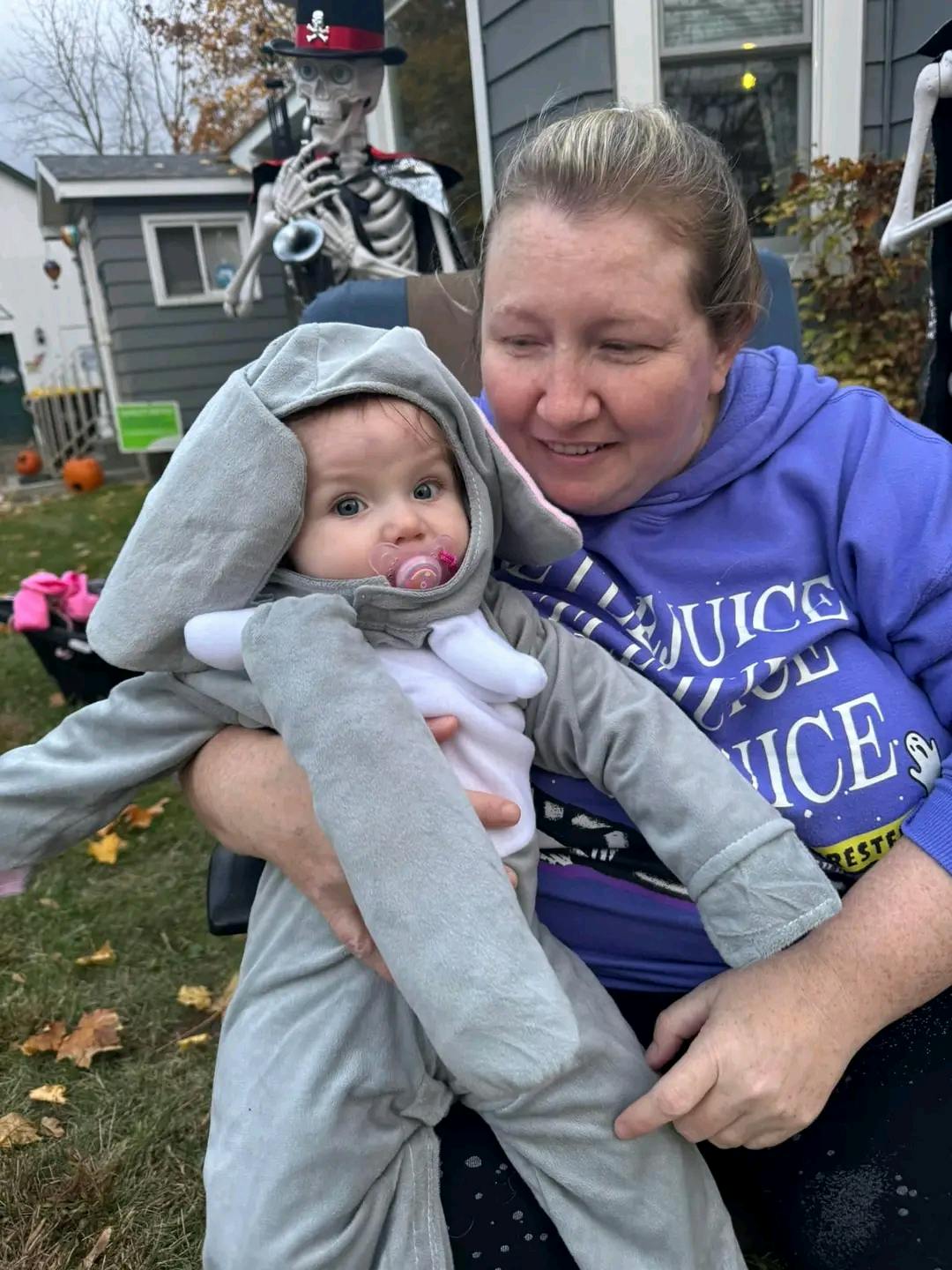 Person holding a child in an animal costume