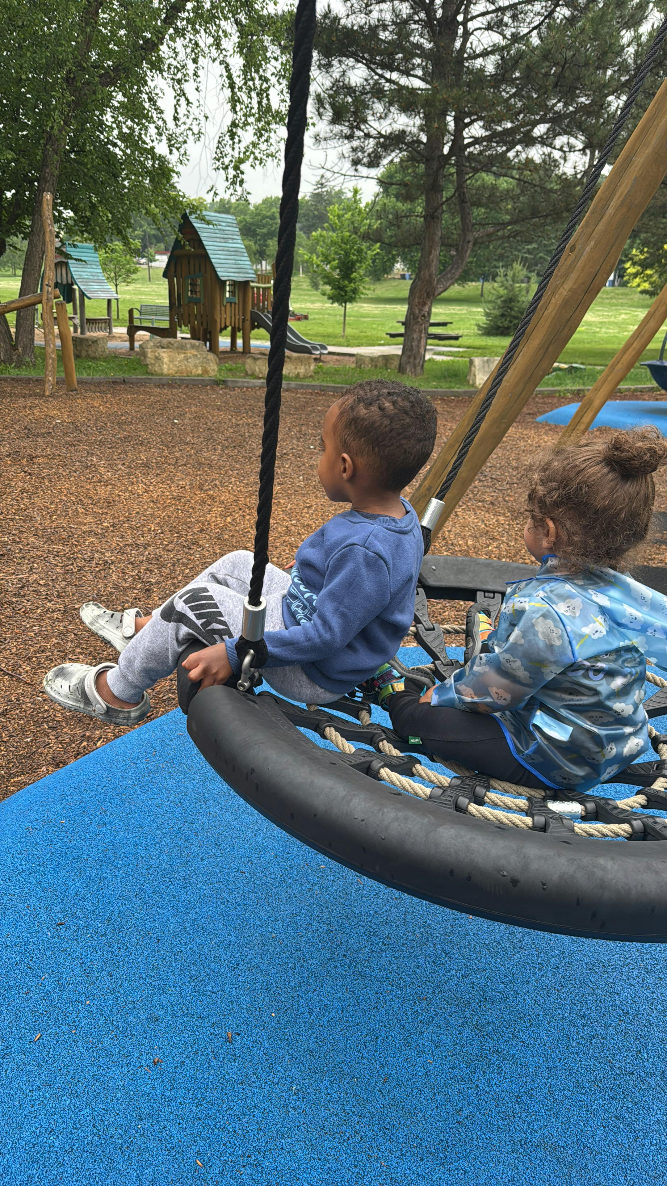 Two children on a playground swing
