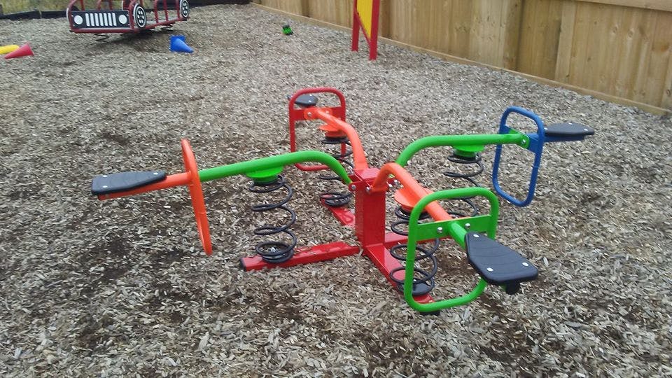 Red and green spring rider on a playground