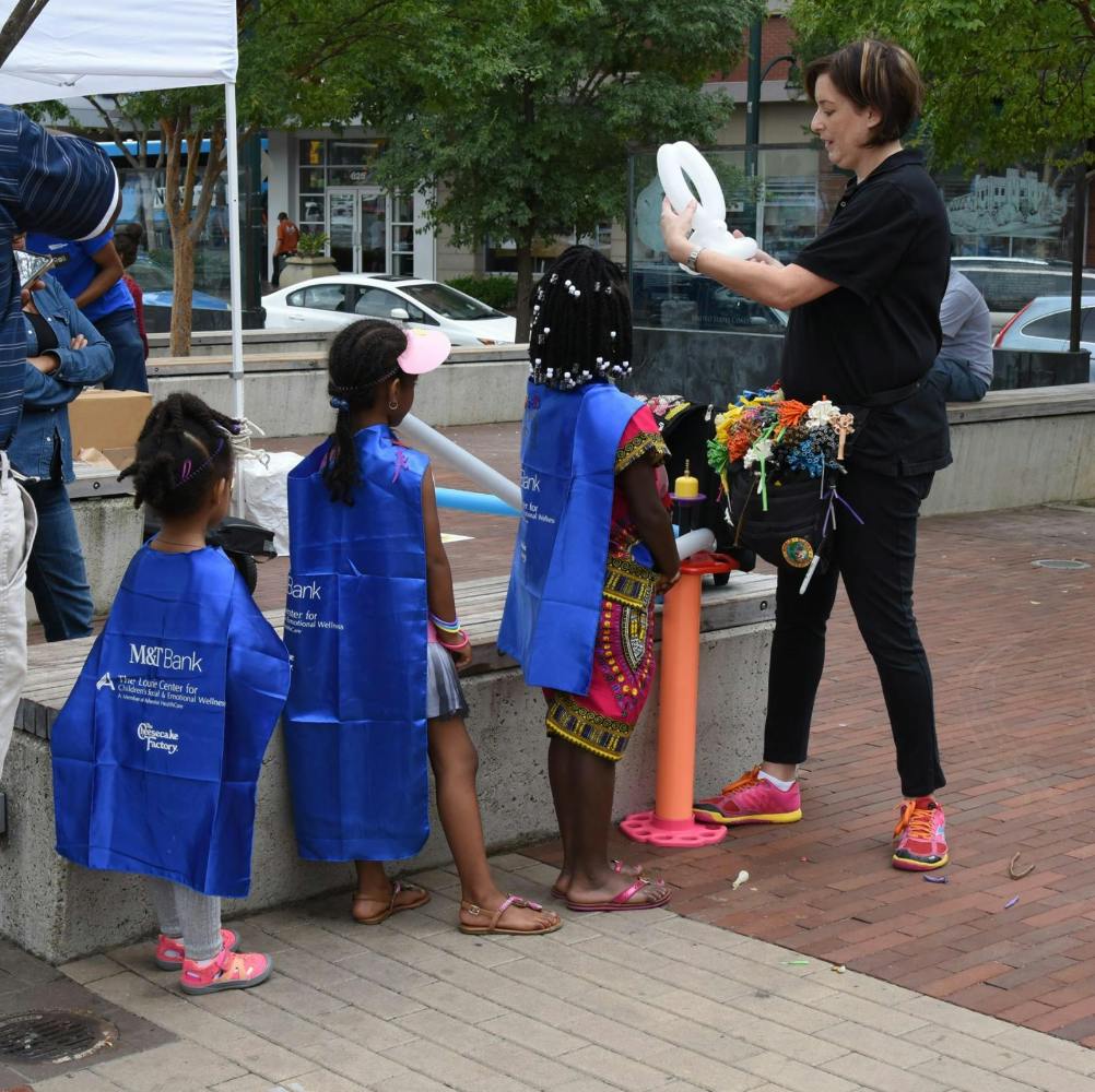 Person making balloon animals for children