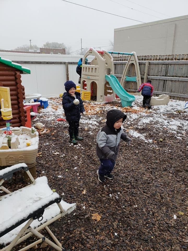 Children playing in a snowy playground