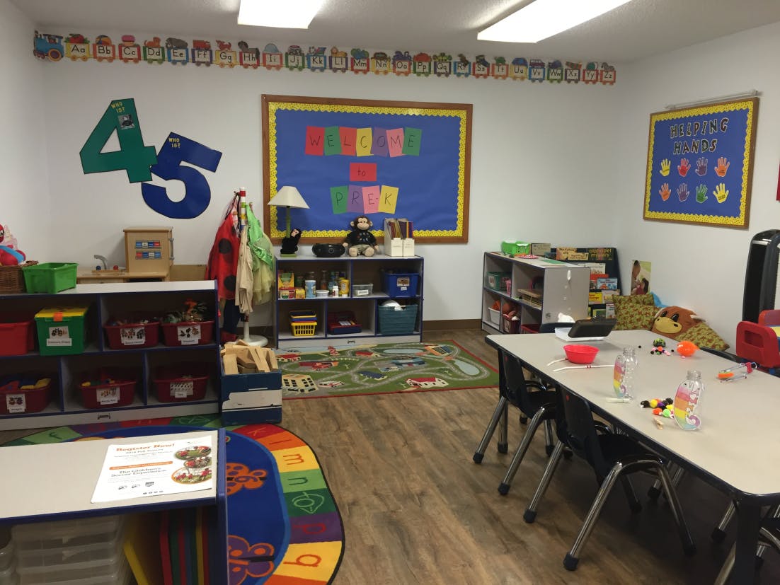 Classroom with tables, shelves, and colorful decorations
