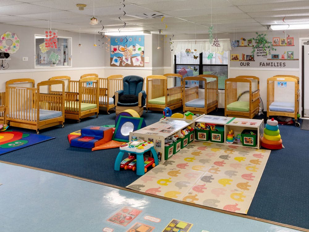 Cribs and play items in a child care room