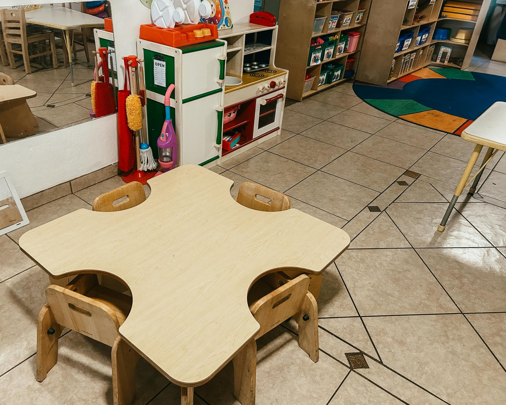 Empty classroom with small tables and chairs