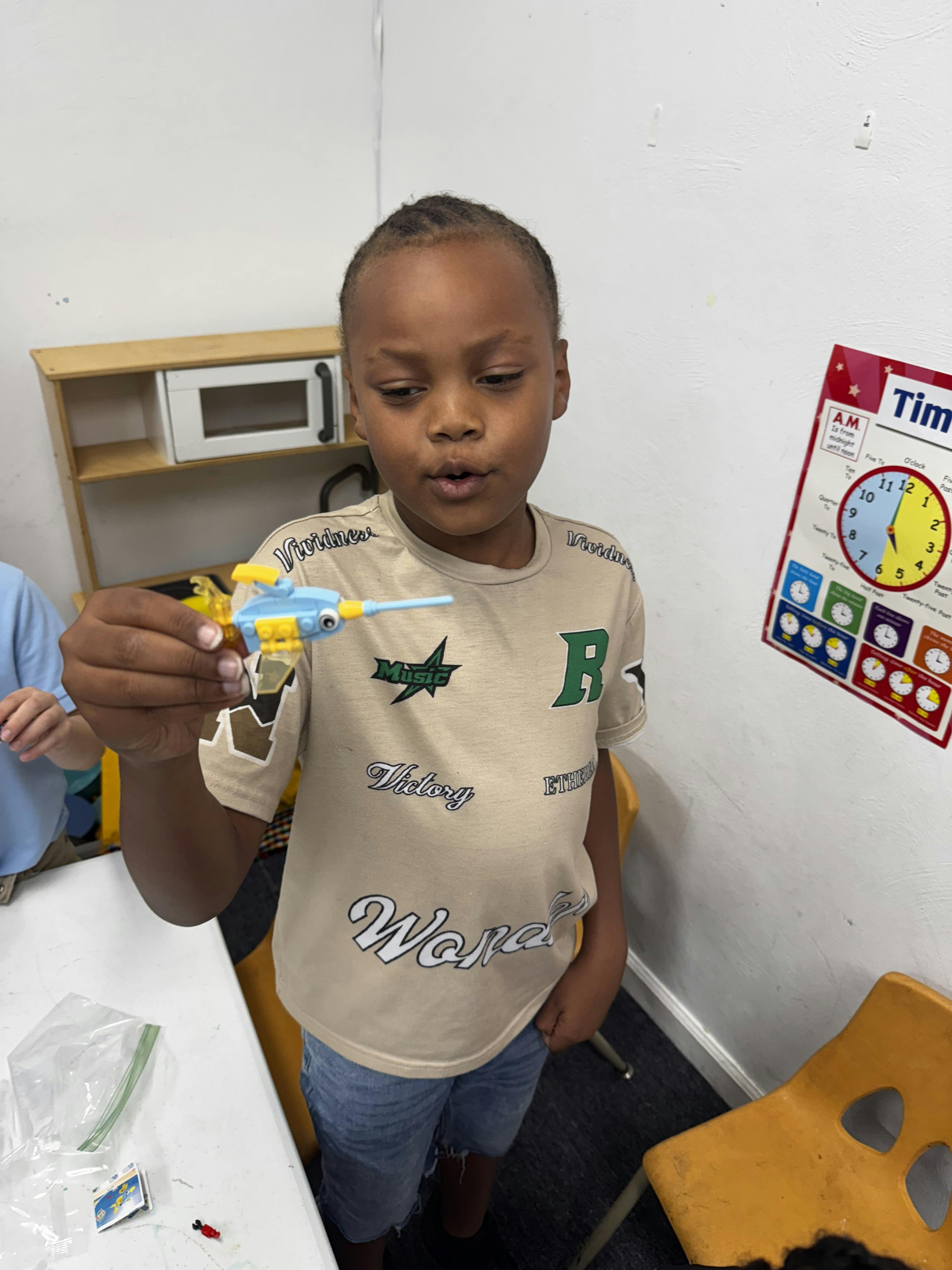Child holding a small toy airplane