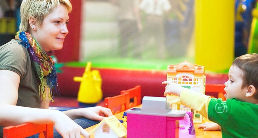 Person and child playing with toys
