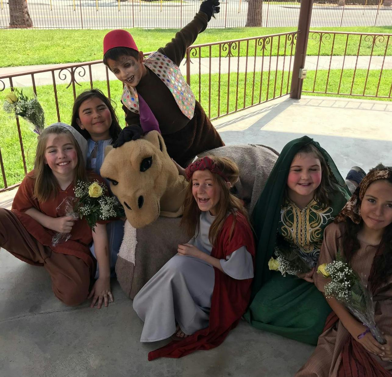 Children in costumes with a person in a donkey costume