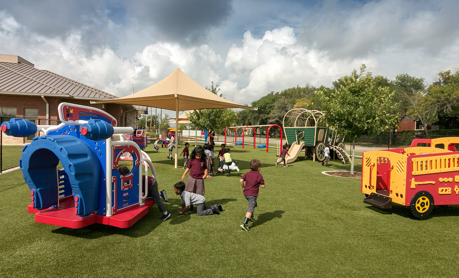Children playing on a playground with play structures