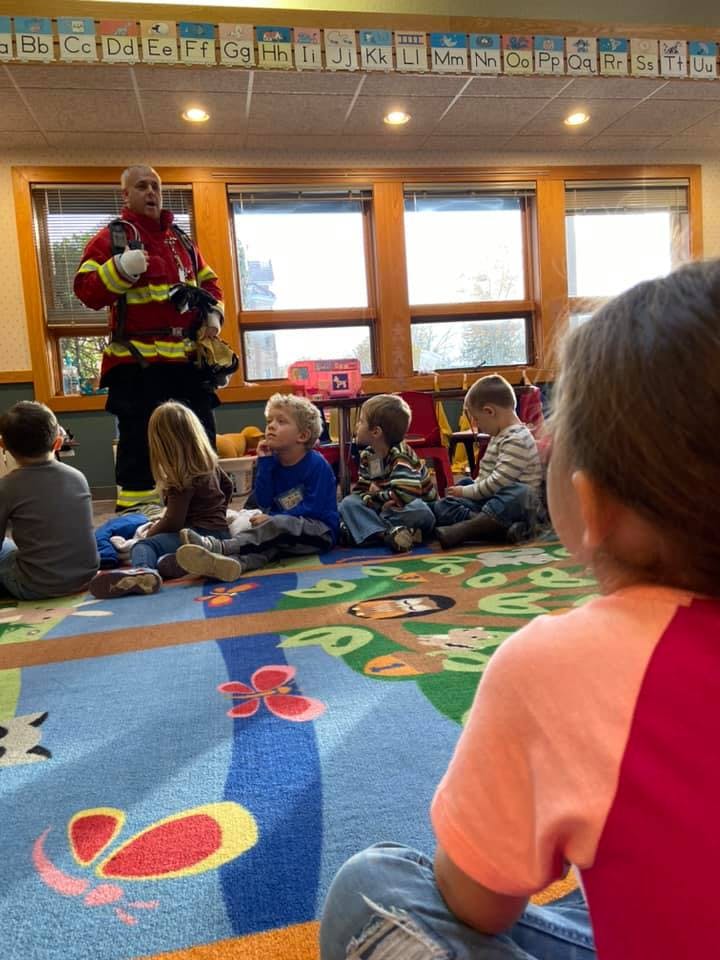 Firefighter speaking to children in a classroom